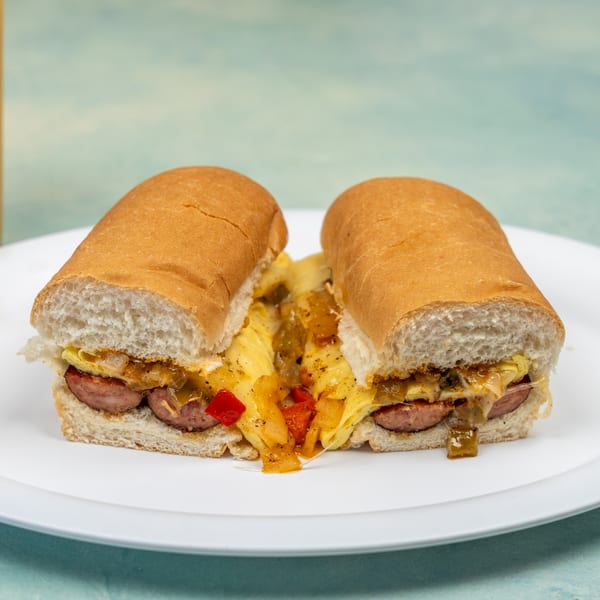 Ellen's Kitchen breakfast sandwich with sausage, eggs, peppers, and onions on a hoagie roll.